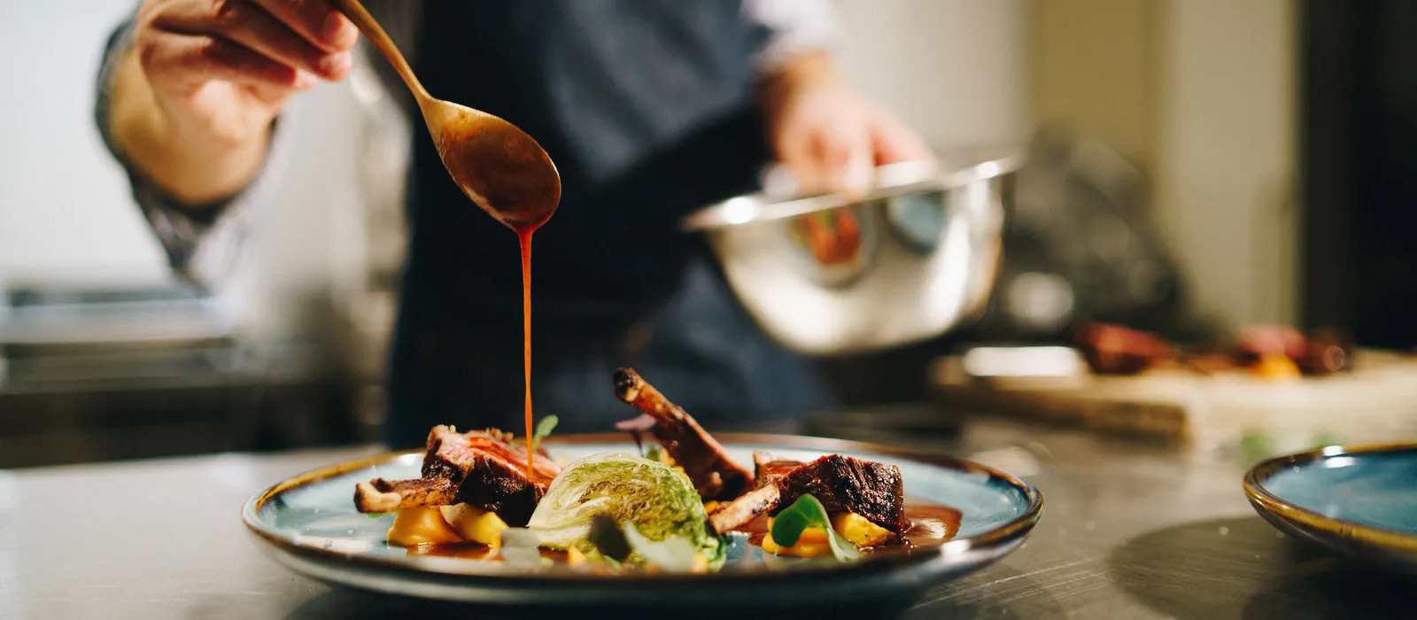 1766132591-chef-pouring-special-sauce-pork-ribs-kitchen (3)